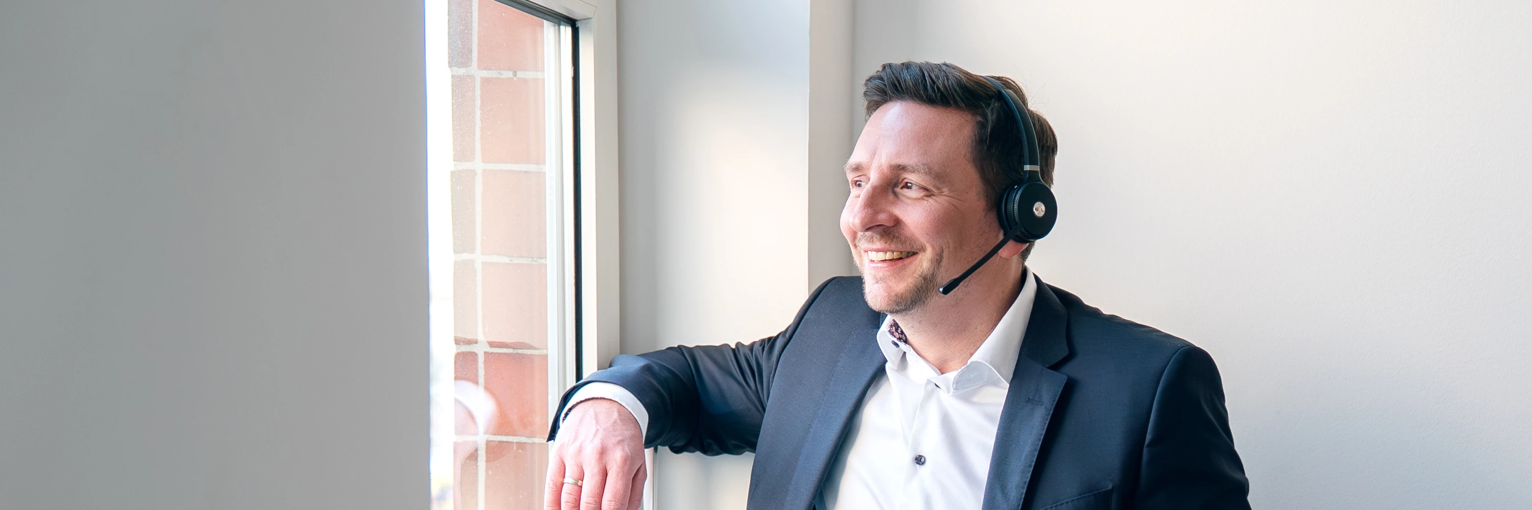Steuerberater Tommy Prachnau im Telefonat am Fenster