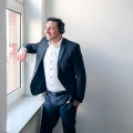 Steuerberater Tommy Prachnau im Telefonat am Fenster